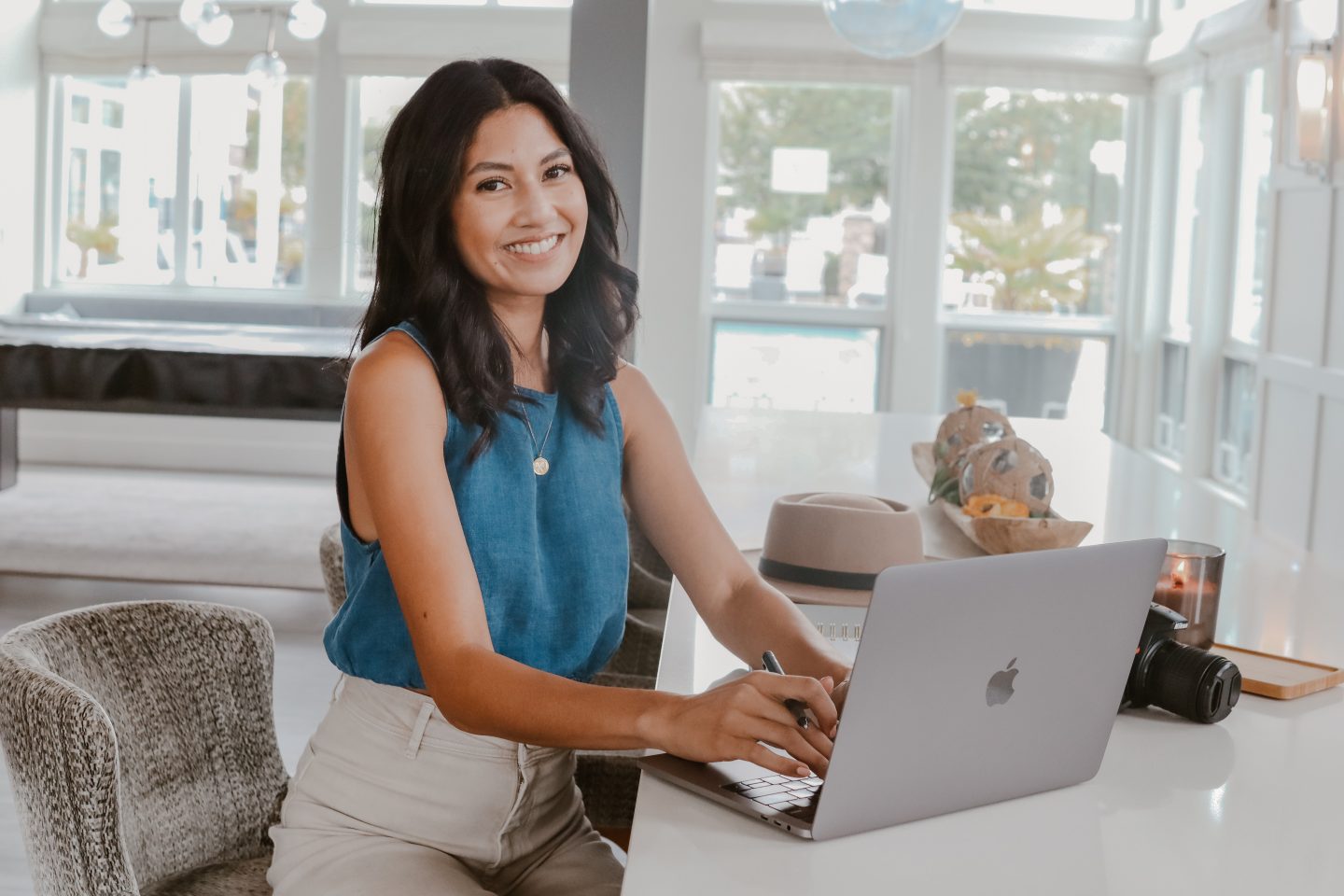 Amanda Breen sitting at the kitchen counter with her laptop