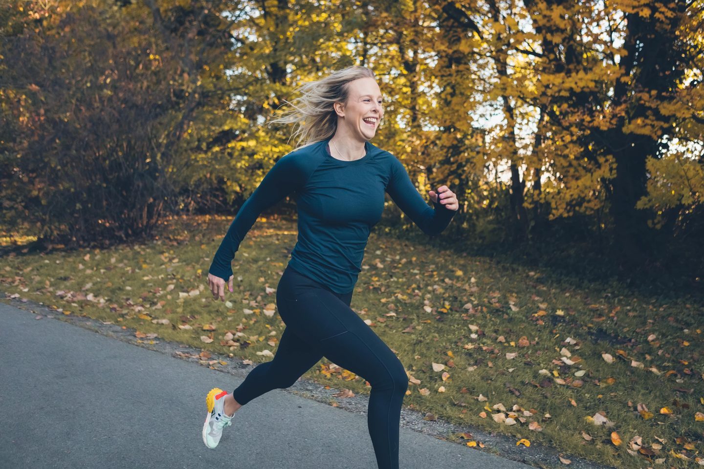 woman happily running in the woods